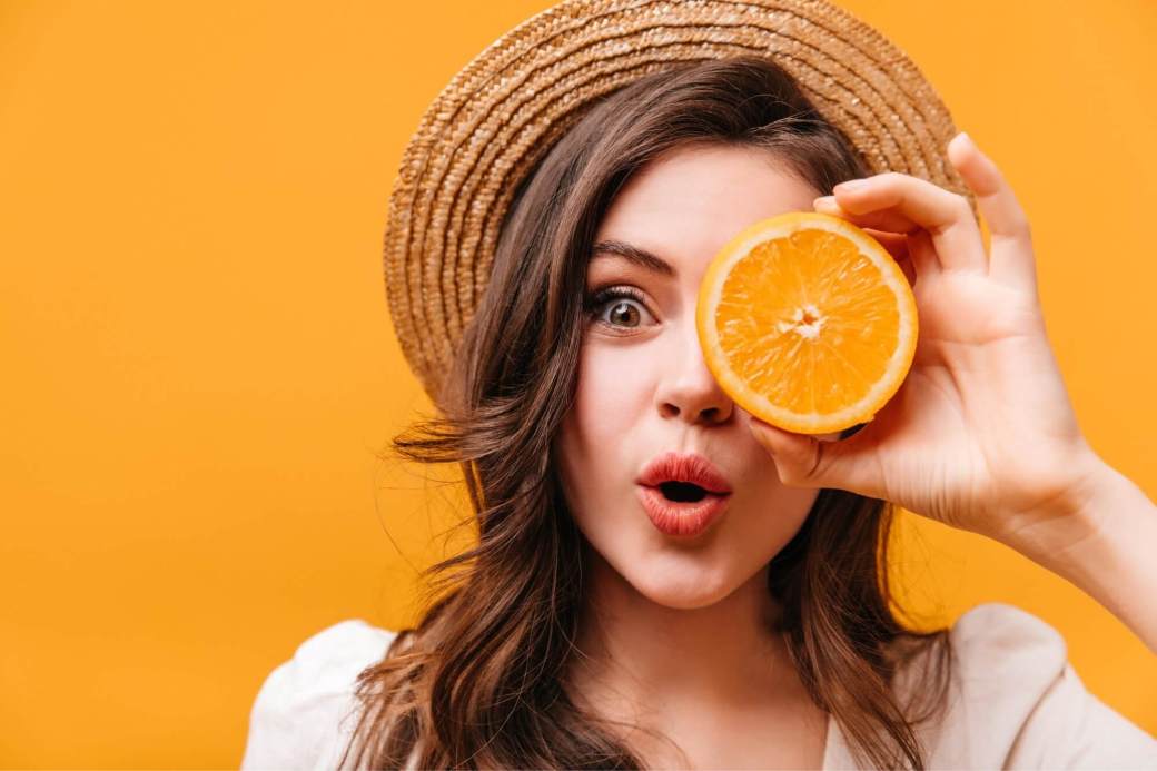 girl with fresh orange fruit