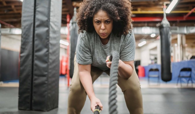 Girl with curls in a gym for weight loss