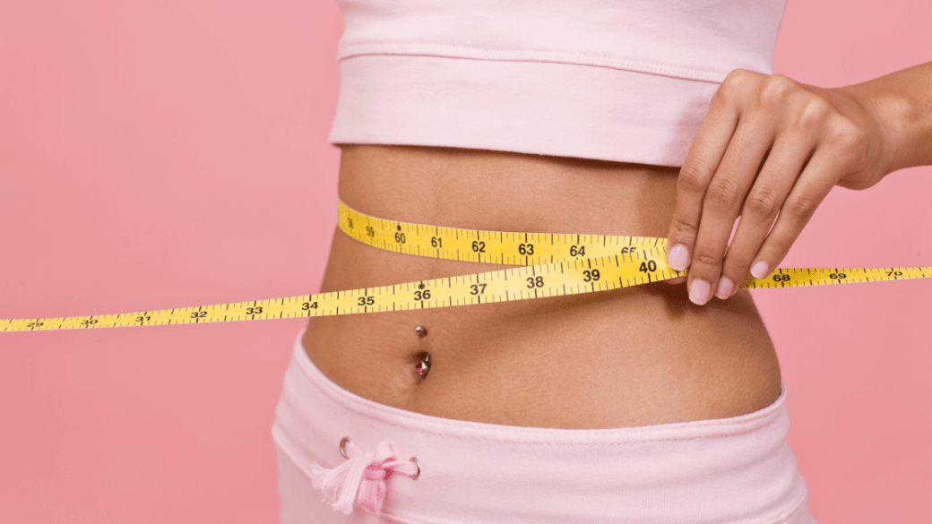Girl measuring her weight loss with pcos